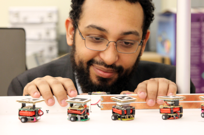 Gheric Speiginer displays his augmented reality interface that shows how robots are functioning