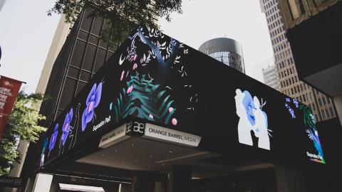 a billboard marquee showing flowers and a couple dancing