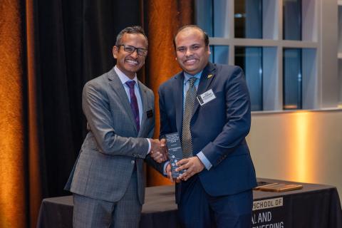 Arijit Raychowdhury (right) receiving the Purdue ECE OECE award from Milind Kulkarni, interim head of the Elmore Family School of Electrical and Computer Engineering.