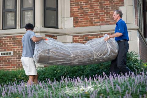 President G.P. "Bud" Peterson (right) helps with move-in in 2012