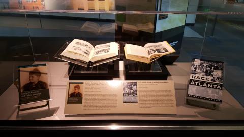 Glass case displaying historic books about Atlanta and the South