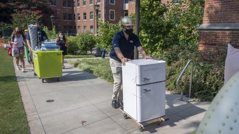 Georgia Tech President Ángel Cabrera pushes a refrigerator to a room for a first-year student moving into on-campus housing during the first weekend of move-in ahead of the 2020-21 academic year. (Photo: Christopher Moore)