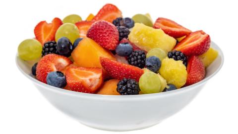 Fruit salad in a white bowl.
