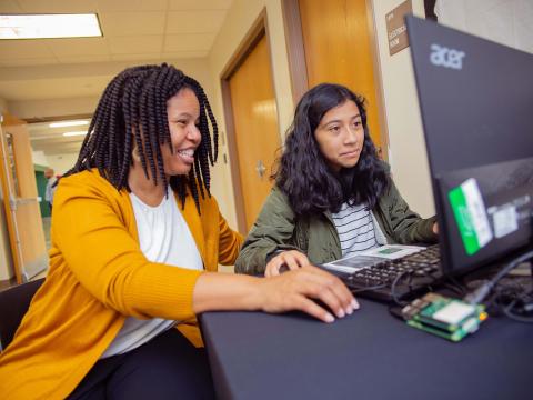 Yolanda Payne helps a student code an emoji during Computer Science Education Week 2019.