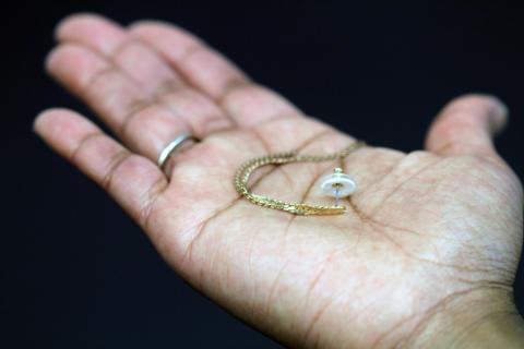 Contraceptive earring in a hand