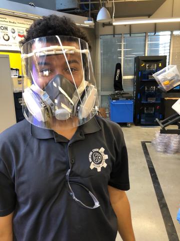 Researcher modeling face shield