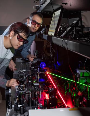 Researchers with laser setup
