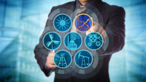 A stock image of a man manipulating symbols representing sustainable energy.