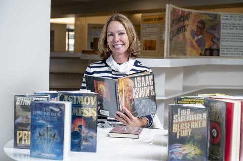 Kathy Betty with science fiction books she donated to the Georgia Tech Library