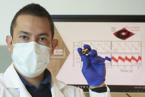 Researcher holding ring-shaped organic photodiode