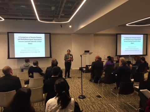 A photo of School of Economics Associate Professor Shatakshee Dhongde presenting at the World Bank/IARIW Conference in Washington, D.C.