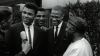 Black and white film still from 'Blood Brothers: Muhammad Ali & Malcom X' on Netflix showing both men being interviewed in a candid photo