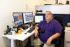Jeff Wiley, IT support specialist in Facilities Management, at his desk in O'Keefe.