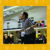 female basketball official blowing a whistle