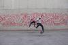 360 flip by Shan Suen and kickflip by Chris Metz in front of MACBA mural in Barcelona 