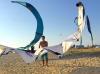 A co-founder of Board Off on the beach with kitesurfing sails