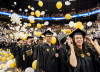 Georgia Tech graduating students with balloons falling at the Fall commencement ceremony in the McCamish building. 