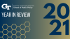 The School of Public Policy logo, text "Year in Review," a honeycomb design, and a giant 2021 all overlaid on top of a navy to gold gradient.