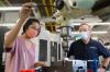 Steven Sheffield, machine shop manager, works with Gwen Wang, mechanical engineering student, in the Montgomery Machining Mall. 