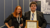 Quintin Kreth poses with a woman from the ASEE, holding a plaque for best paper from the Engineering Ethics Division.