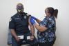 Captain Marcus Walton receives the Covid-19 vaccine from Anndrea Terrell with Stamps Health Services.