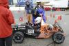 photograph of Sam Gilmer and driver Nathan Cheek getting ready for next event