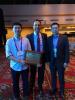 photograph of Sensen Li with Dr. Walid Ali-Ahmad (Facebook, Conference General Chair of 2018 IEEE RFIC) and ECE Assistant Professor Hua Wang