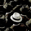 A man with a white hat in a crowd of black hats.
