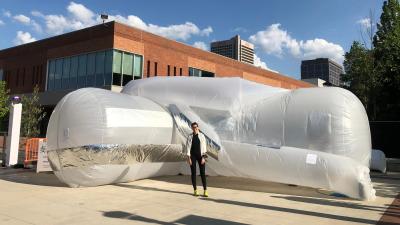 Noura Howell stands in front of her inflatable sculpture &quot;Infrastructural Membranes.&quot;