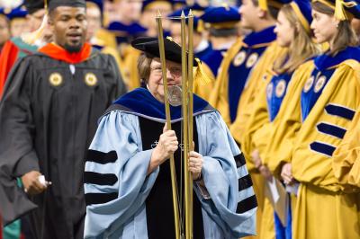 Susan Cozzens carries the mace at Commencement