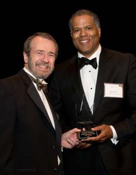 Guy Primus (right) accepts Outstanding Young Engineering Alumni Award from Dean Giddens