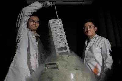 Gabe Kwong (r.) with vat that stores T cells in his lab at Georgia Tech