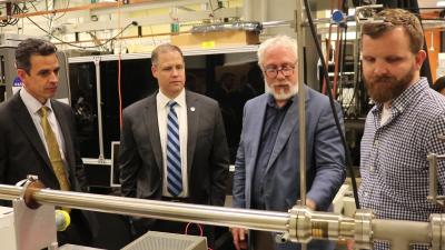 (From left) Georgia Congressman Tom Graves, NASA Administrator Jim Bridenstine, School of Chemistry and Biochemistry Professor Thom Orlando, and postdoctoral researcher Zach Seibers in the REVEALS lab. (Photo by Renay San Miguel)