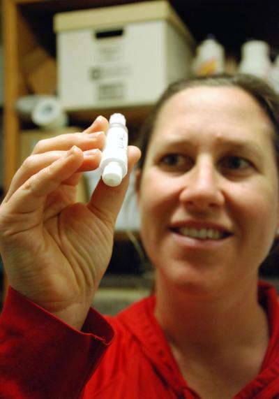 Nastassia Patin, postdoctoral researcher in the School of Biological Sciences, holds a water sample taken during her study of blue holes off Florida&#039;s western coast. 