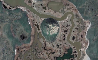 Ibyuk Pingo in Canada, as seen from directly above. Mars, Ceres, and the Earth have abundant reserves of ground ice. On Earth, ice-cored mounds known as pingos are important indicators of groundwater systems and local climate. Credit: Google Earth