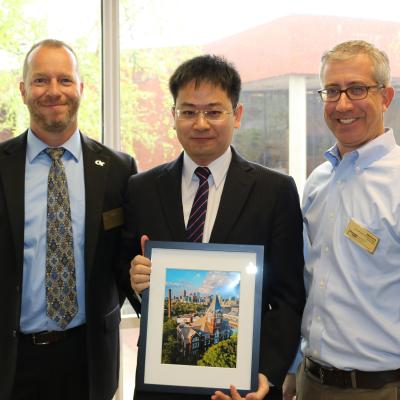 H. Milton and Carolyn J. Stewart School Chair Edwin Romeijn and Associate Chair for Graduate Studies Alan Erera with Xiaolei Fang, winner of the Alice and John Jarvis Ph.D. Student Research Award