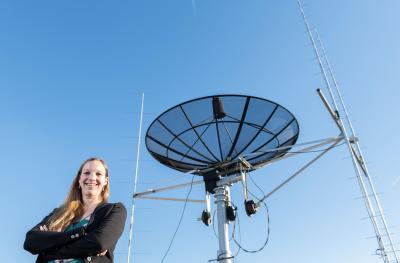 Mariel Borowitz with satellite communications equipment