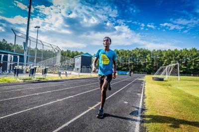 Biya Haile running cross country in high school
