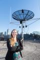 Mariel Borowitz with satellite communications equipment (vertical)