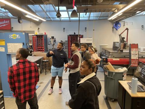 Flowers Invention Studio tour in progress. The water jet machine is shown on the upper-right side.