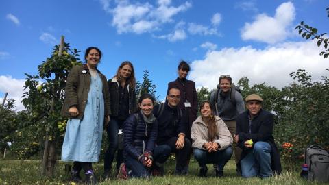 Group photo of researchers in an apple orchard