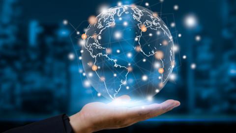 Stock image of a transparent globe and a hand