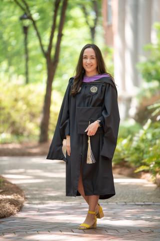 full length photo of Heidi Davari wearing commencement robe