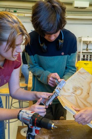 The team working in the College of Design’s woodworking space during the squirrel box-building event. Photo credit: Thomas Bordeaux, ARCH 2022. 