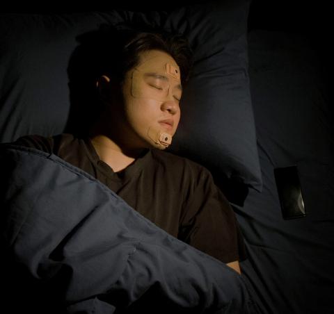 Georgia Tech Associate Professor W. Hong Yeo is shown sleeping  with the wearable sleep apnea detection and sleep quality monitoring device he and a team of researchers and clinicians created.