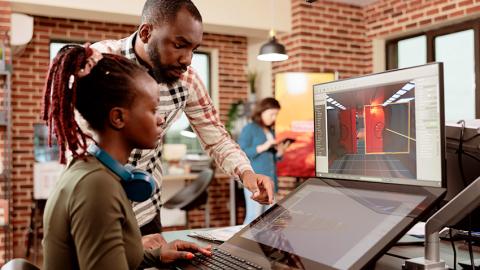 Computational media students collaborating on a video game design