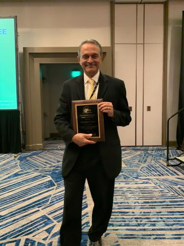 Photo of ECE Professor Deepakraj M. Divan with the 2023 Nari Hingorani Custom Power Award plaque.