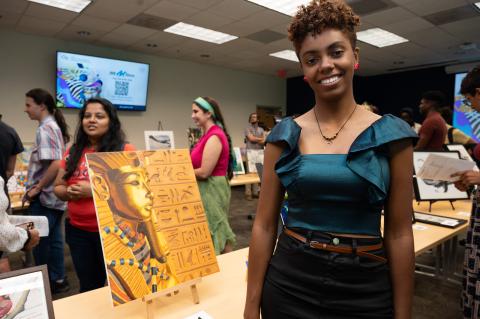 Belinda Person with her painting titled "Messages From the Past" at the IBB Art Show. 