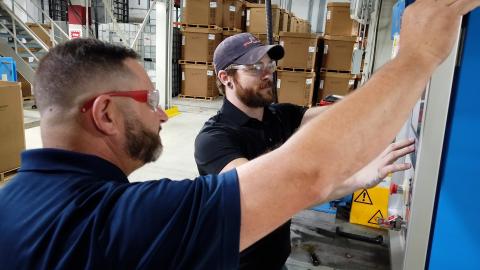 This image shows technicians at Silon, a company in Peachtree City, Georgia working from a monitoring screen in their plant.