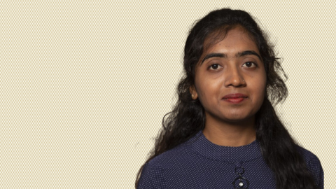 Headshot of Roshani on a gold patterned backround